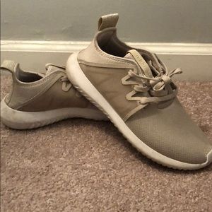 Tan Adidas tubular sneakers
